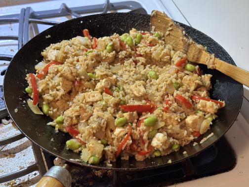 Fried rice in a wok, on a grubby gas stove.